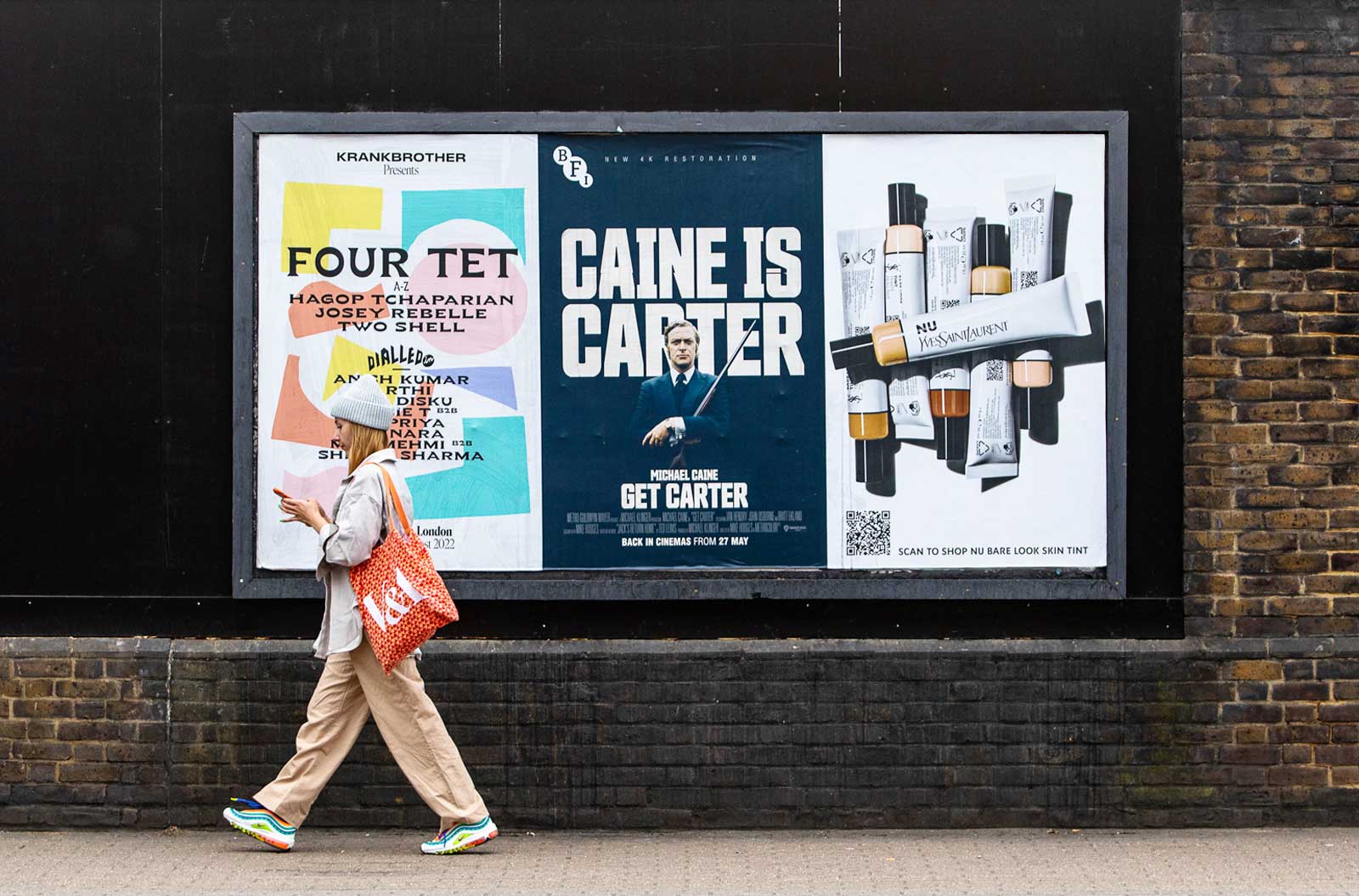 Street Musician Standing In Front Of An Advertisement Poster High